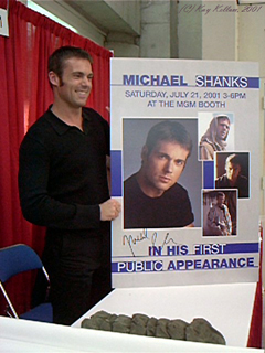 Michael Shanks poses briefly with the poster announcing his signing